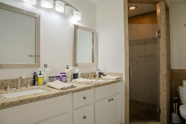 bathroom featuring walk in shower, vanity, and toilet