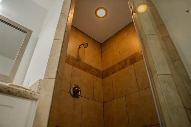 interior details featuring tiled shower