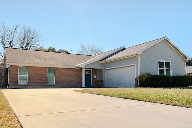 ranch-style home with a garage and a front lawn