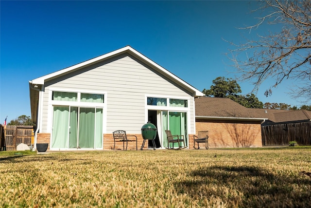 back of property with a lawn