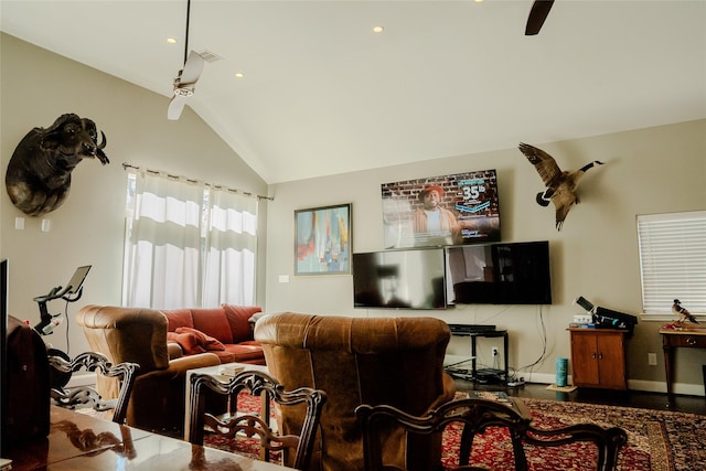 living room featuring ceiling fan and vaulted ceiling