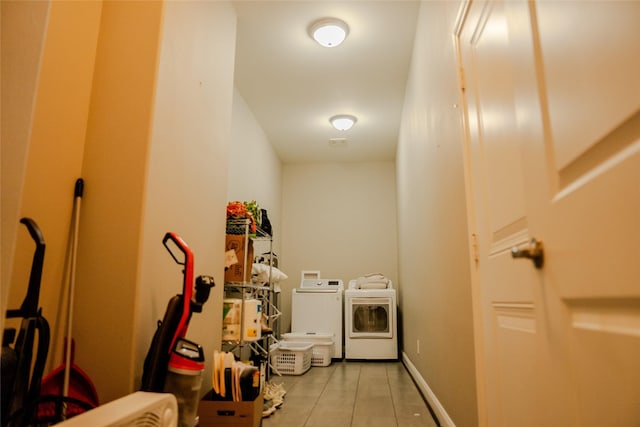 laundry room with light tile patterned floors and washing machine and clothes dryer