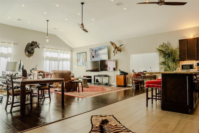 living room featuring vaulted ceiling and ceiling fan