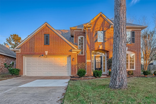 front facade featuring a garage and a front lawn