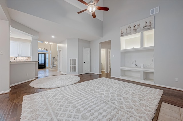 bedroom with sink, wood-type flooring, high vaulted ceiling, and ceiling fan