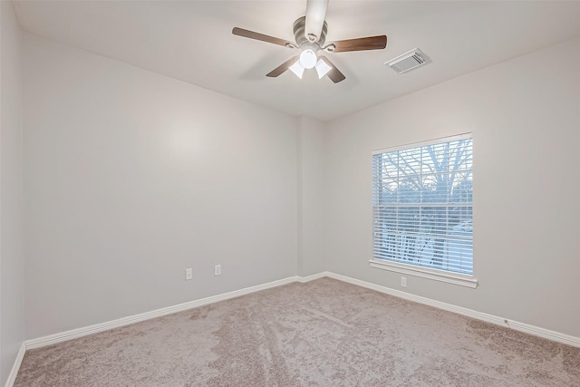 carpeted spare room with ceiling fan