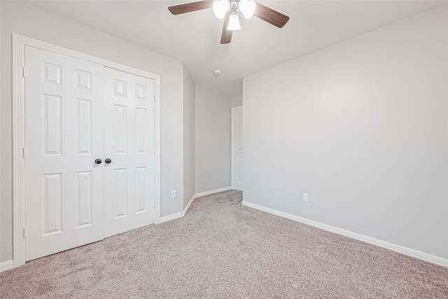 unfurnished bedroom featuring ceiling fan, light carpet, and a closet