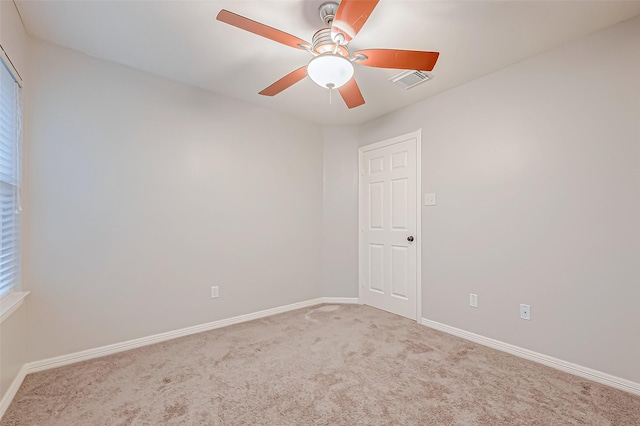 spare room featuring carpet and ceiling fan