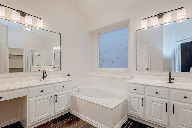 bathroom featuring vanity, lofted ceiling, and separate shower and tub