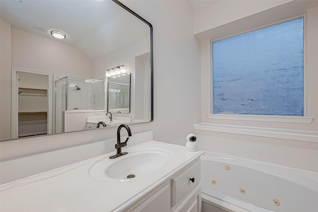 bathroom with lofted ceiling, independent shower and bath, and vanity