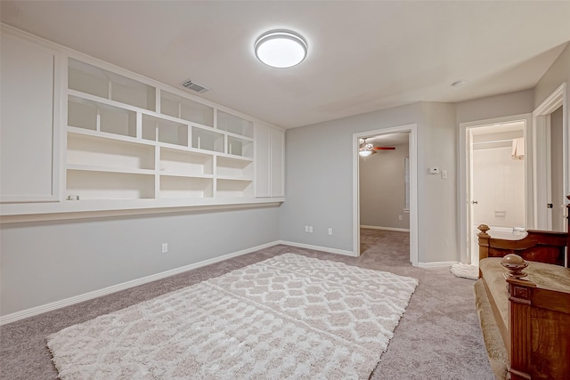 interior space featuring carpet flooring, ceiling fan, and built in shelves