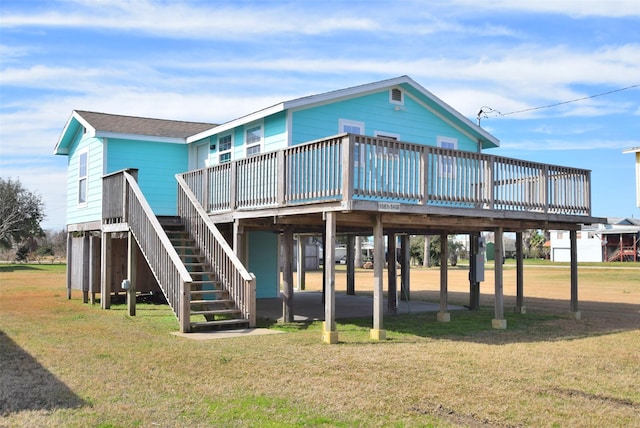 back of property with a deck and a lawn