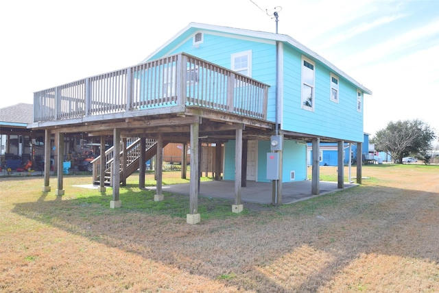 back of property featuring a yard, a patio area, and a deck