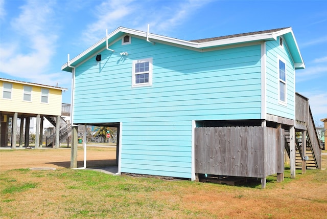 rear view of property featuring a lawn