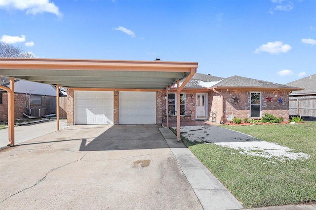 view of front of house featuring a garage, a front yard, a carport, and central air condition unit