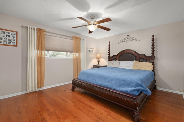 bedroom featuring hardwood / wood-style flooring, a textured ceiling, and ceiling fan