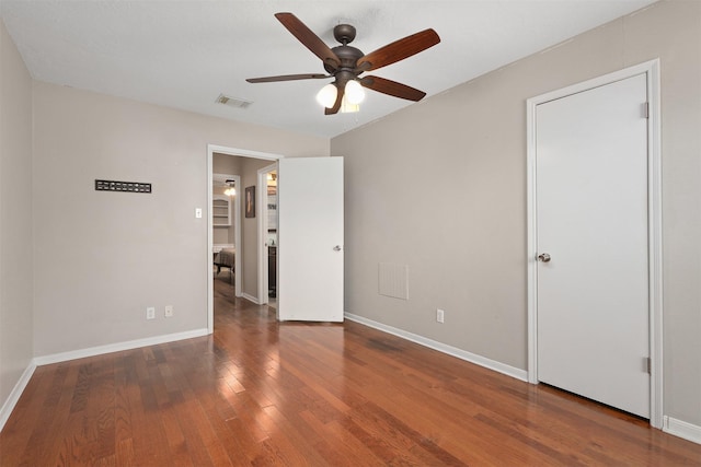 interior space with dark hardwood / wood-style flooring and ceiling fan