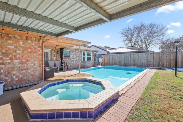 view of pool with an in ground hot tub