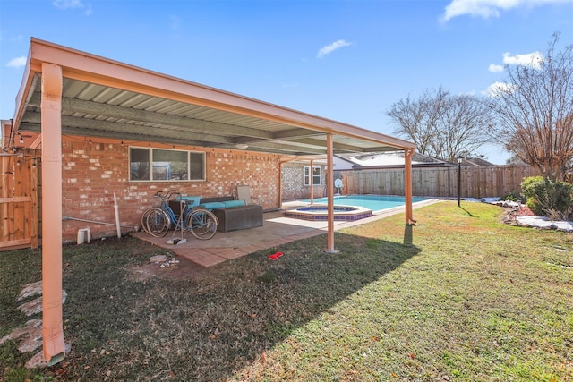 view of yard featuring a patio and a pool with hot tub