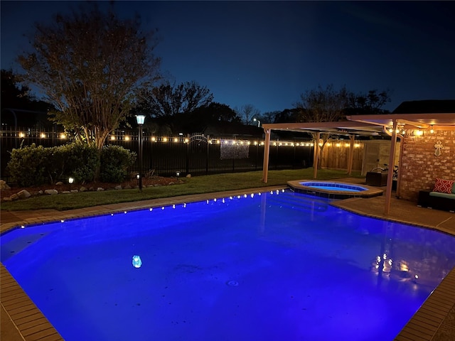 pool at twilight with an in ground hot tub