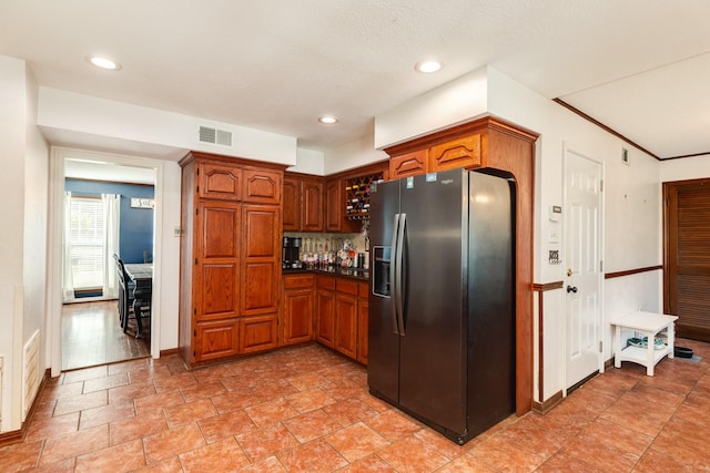 kitchen with black fridge with ice dispenser