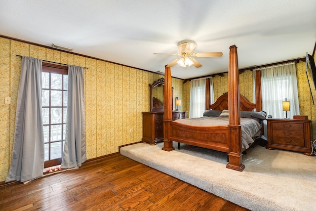 bedroom featuring ornamental molding, dark hardwood / wood-style floors, and ceiling fan