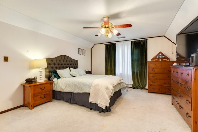 carpeted bedroom featuring lofted ceiling and ceiling fan