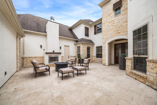 view of patio with exterior fireplace