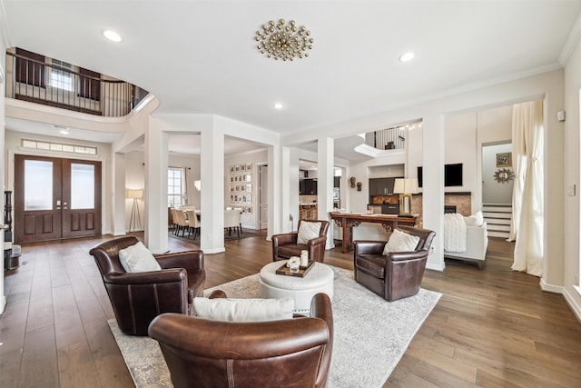 living room featuring crown molding, wood-type flooring, and french doors