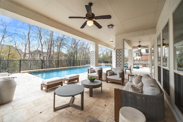 view of pool with an outdoor living space, a patio, and ceiling fan