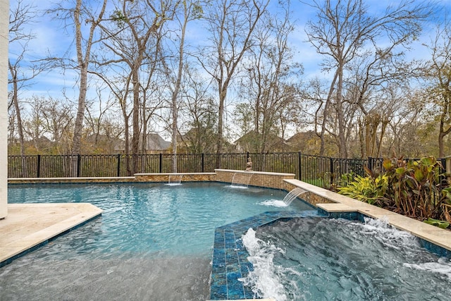 view of pool featuring pool water feature and a jacuzzi