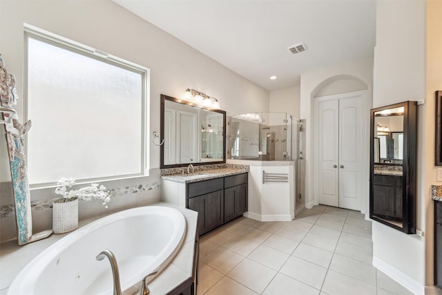 bathroom featuring tile patterned floors, plus walk in shower, and vanity