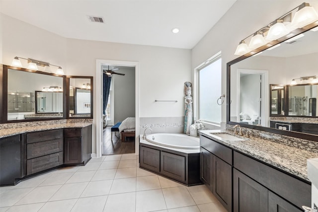 bathroom featuring tile patterned floors, a bathtub, and vanity