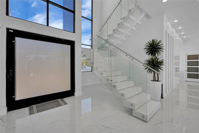 entrance foyer with a towering ceiling and plenty of natural light