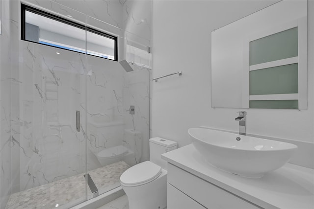 bathroom with vanity, a shower with shower door, and toilet