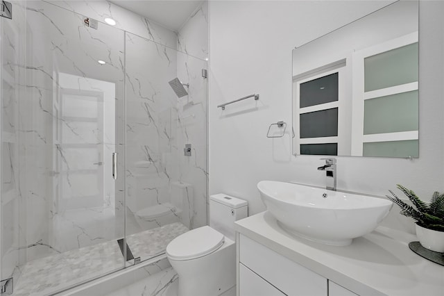 bathroom with walk in shower, vanity, and toilet