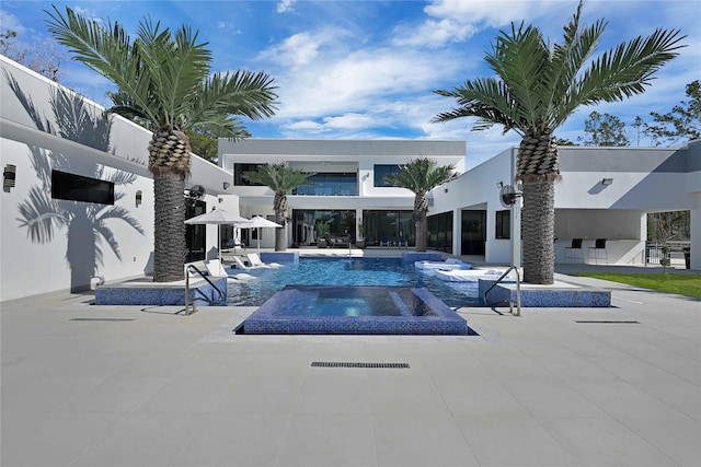 view of swimming pool featuring an in ground hot tub and a patio