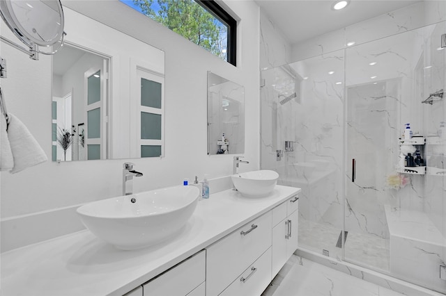 bathroom with a shower with door and vanity