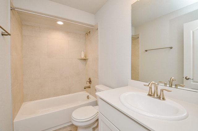 full bathroom with tiled shower / bath, vanity, and toilet