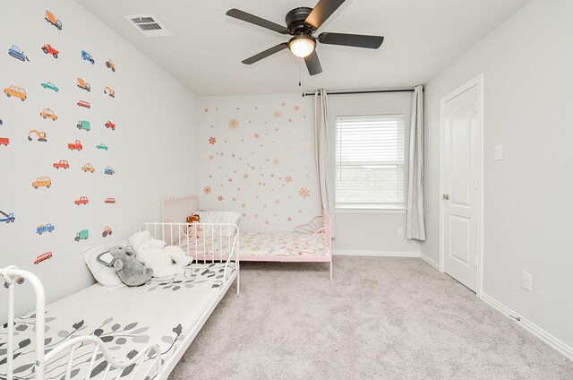 bedroom with light colored carpet and ceiling fan