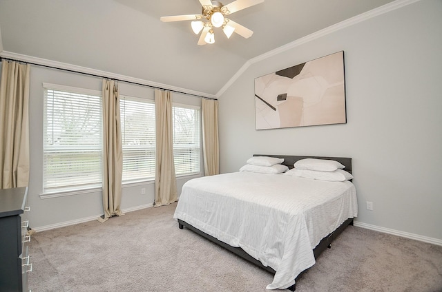 carpeted bedroom with crown molding, vaulted ceiling, and ceiling fan