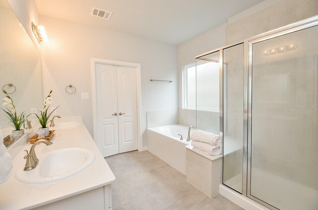 bathroom with vanity and independent shower and bath