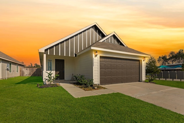 view of front of home featuring a yard and a garage