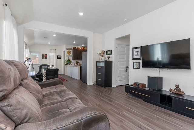 living room featuring hardwood / wood-style flooring, vaulted ceiling, and a wealth of natural light