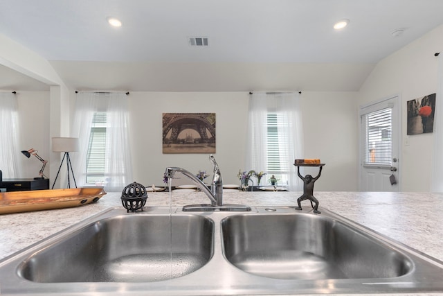 kitchen with lofted ceiling and sink