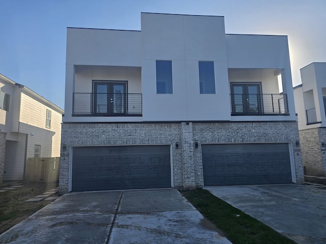 contemporary home featuring a balcony and a garage