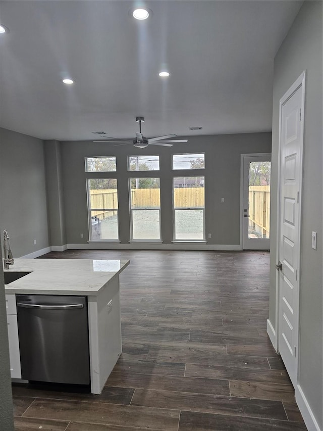 kitchen with a wealth of natural light, dark hardwood / wood-style flooring, dishwasher, and white cabinets