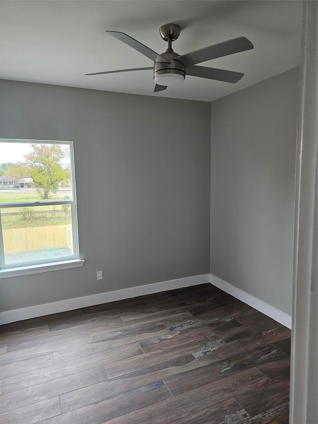 spare room featuring dark hardwood / wood-style floors and ceiling fan