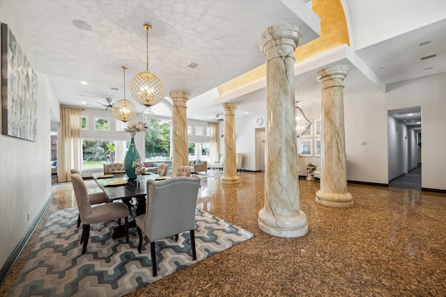 dining area with ornate columns, ceiling fan with notable chandelier, and a wealth of natural light