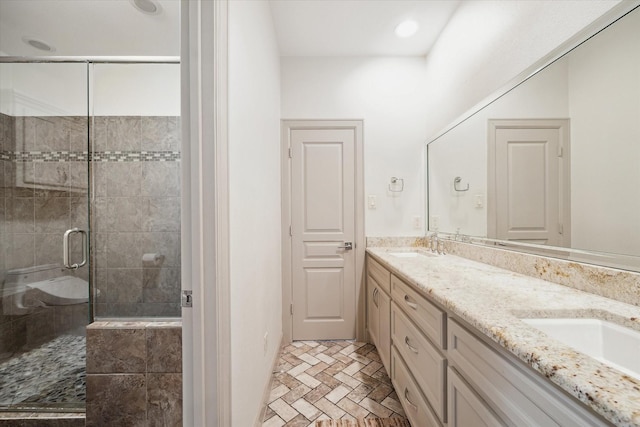 bathroom with vanity and a shower with shower door